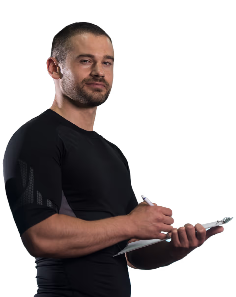 Man in black shirt writing with a pen on a clipboard